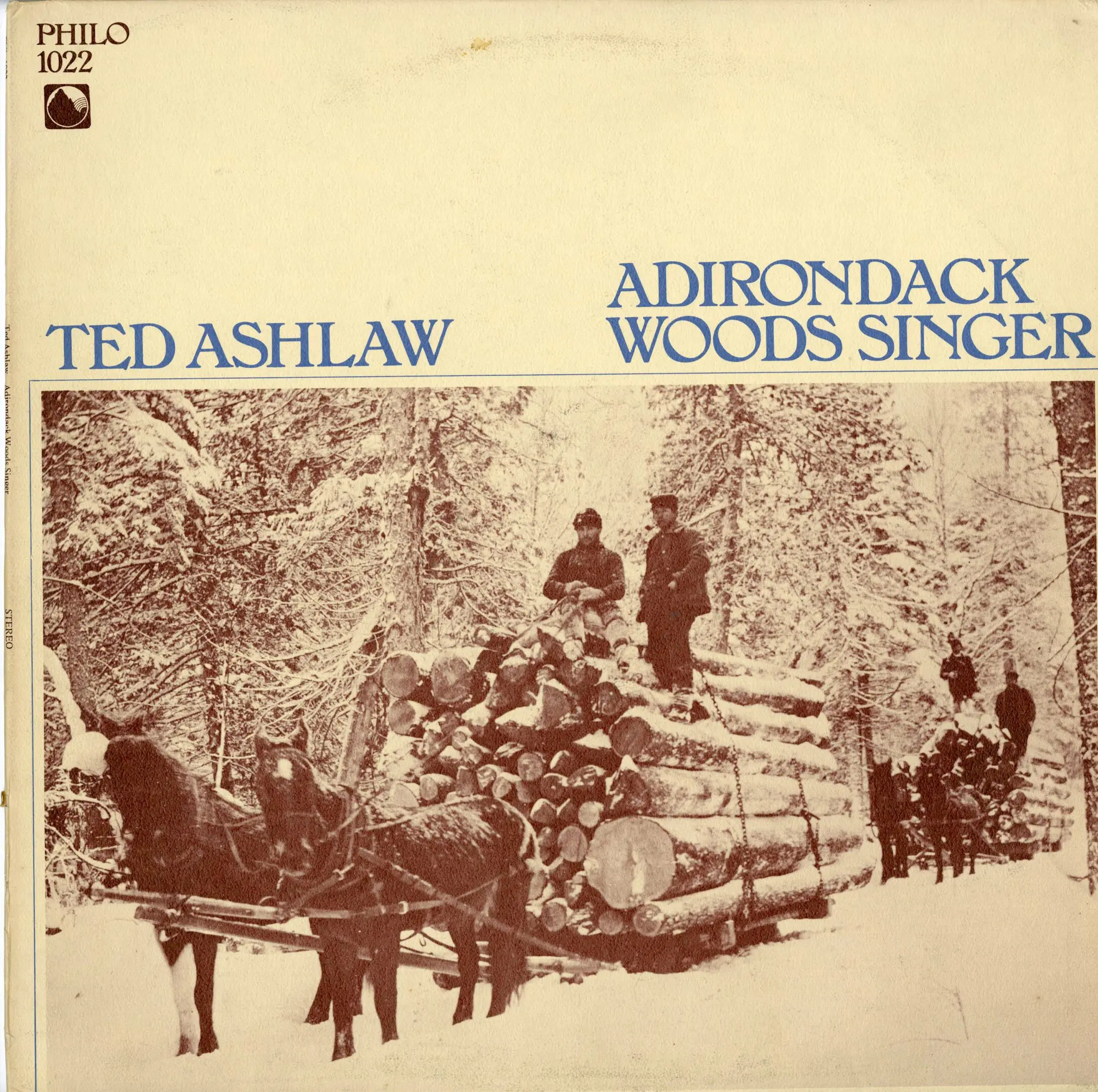 Snowy forest scene with log-laden sled.