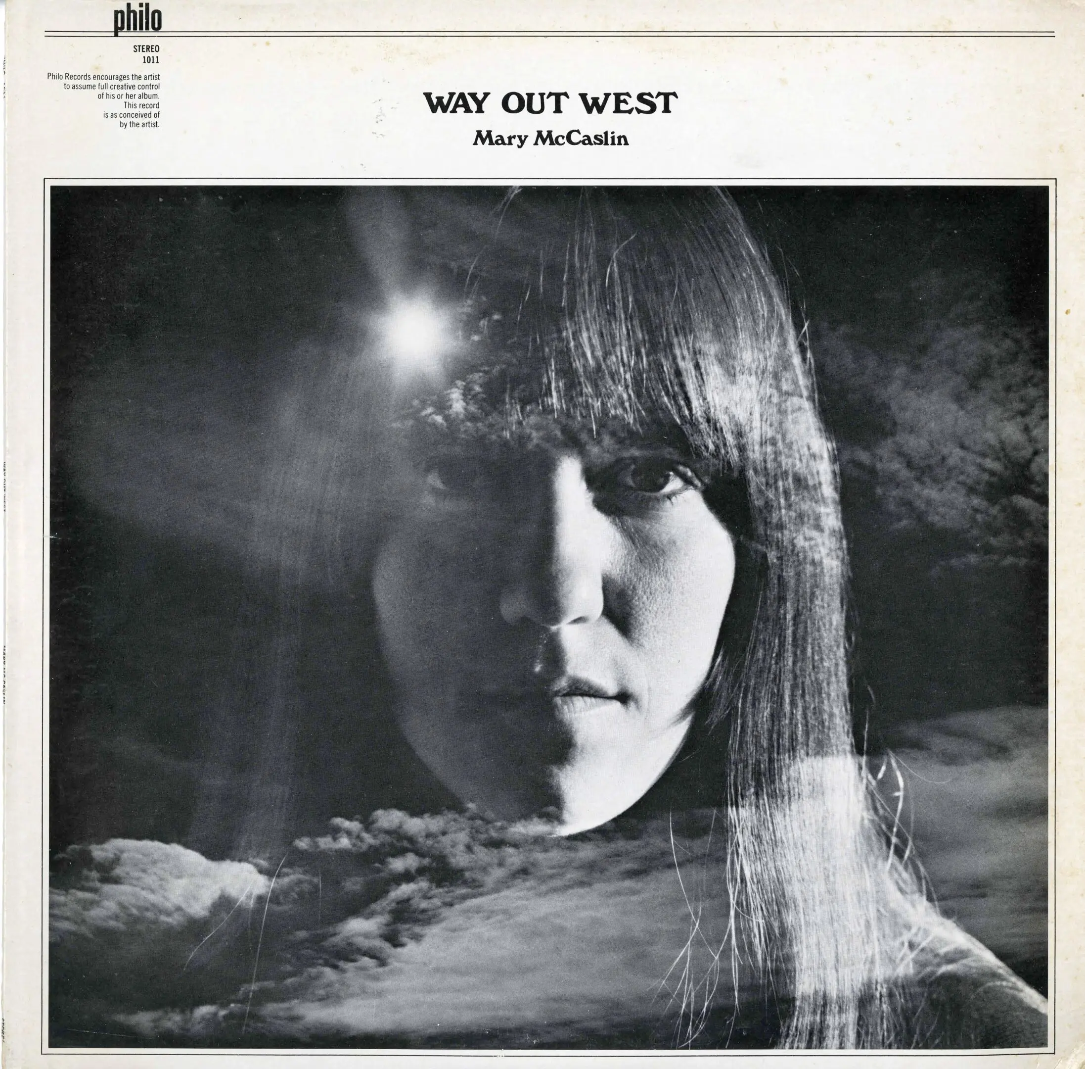 Album cover with woman's face and clouds.