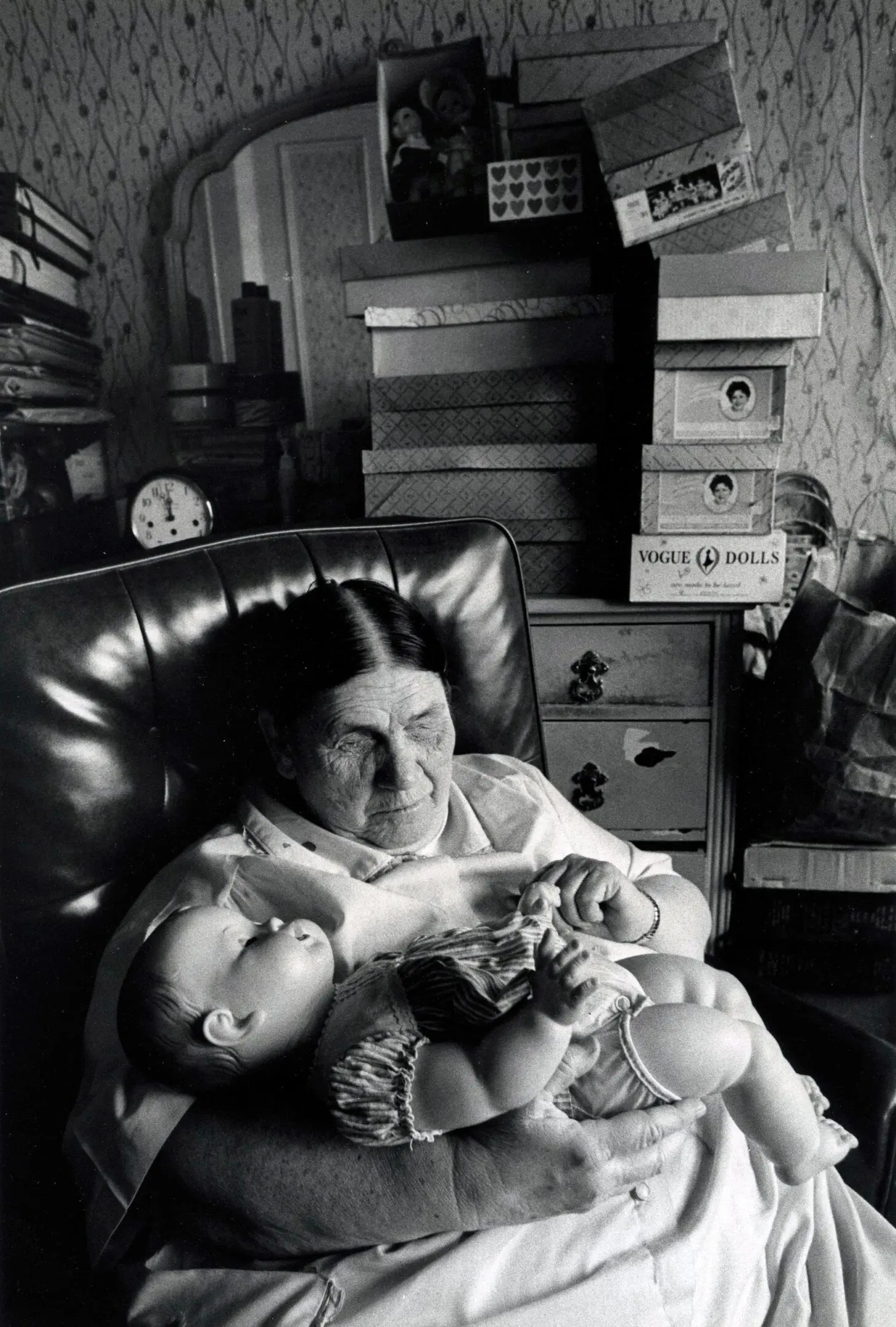 Elderly woman holding a baby doll.