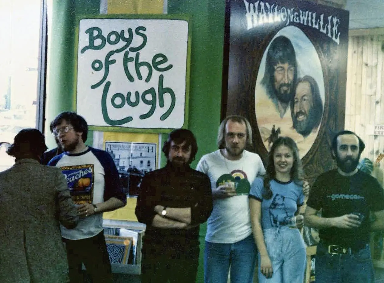 Group posing with "Boys of the Lough" poster.