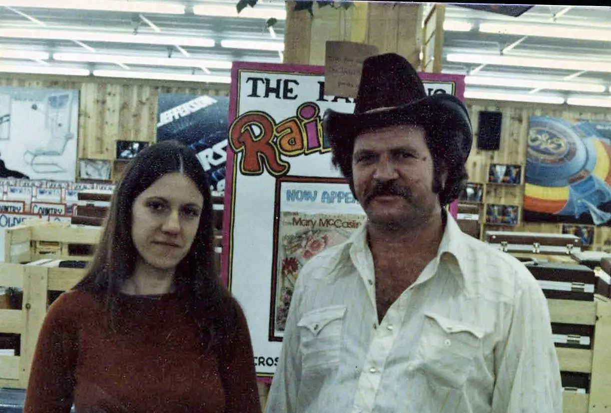 Man and woman in store with posters.