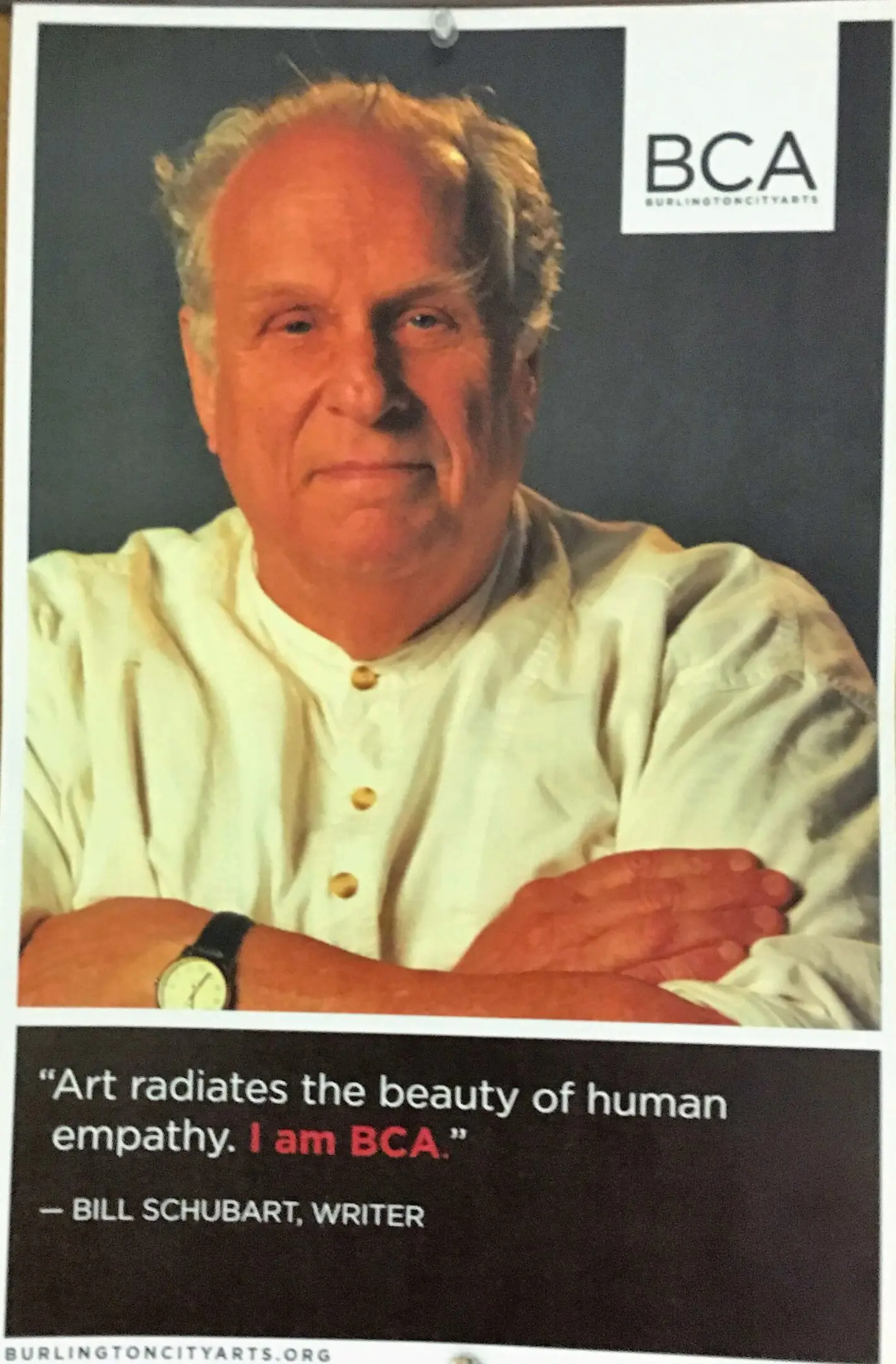 Man in white shirt with folded arms.