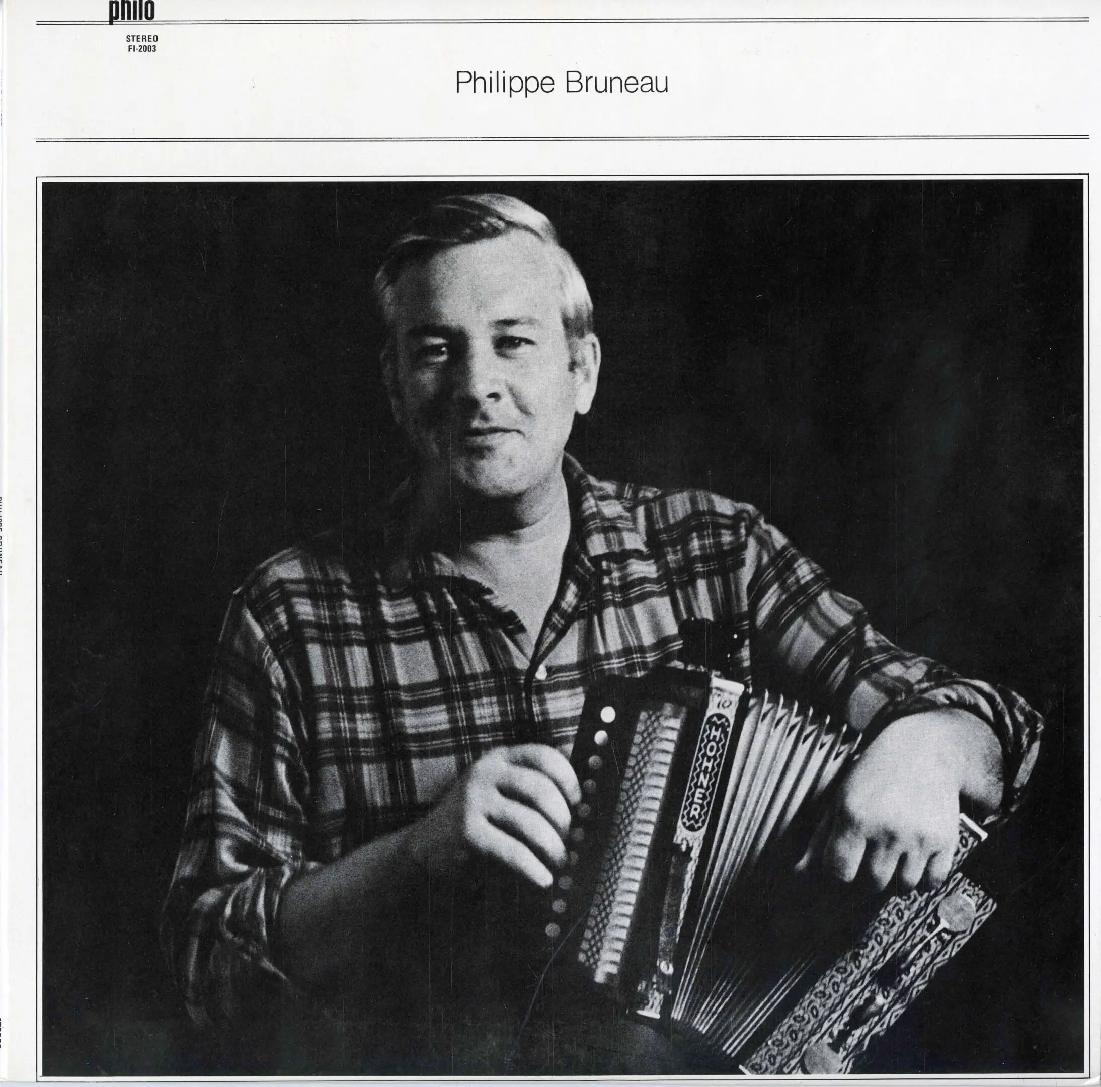 Person playing accordion in black and white.