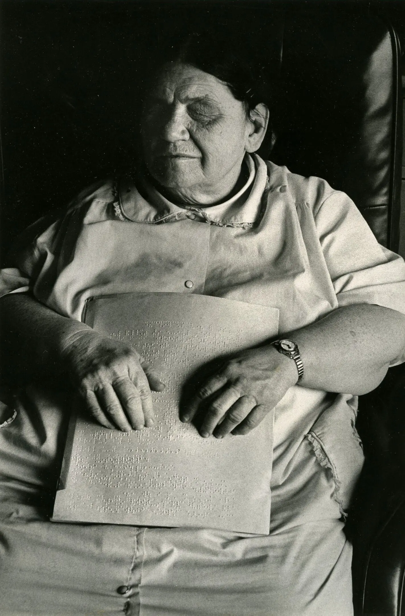 Woman reading braille text with hands.