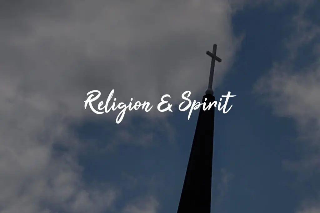 Church steeple under cloudy blue sky.