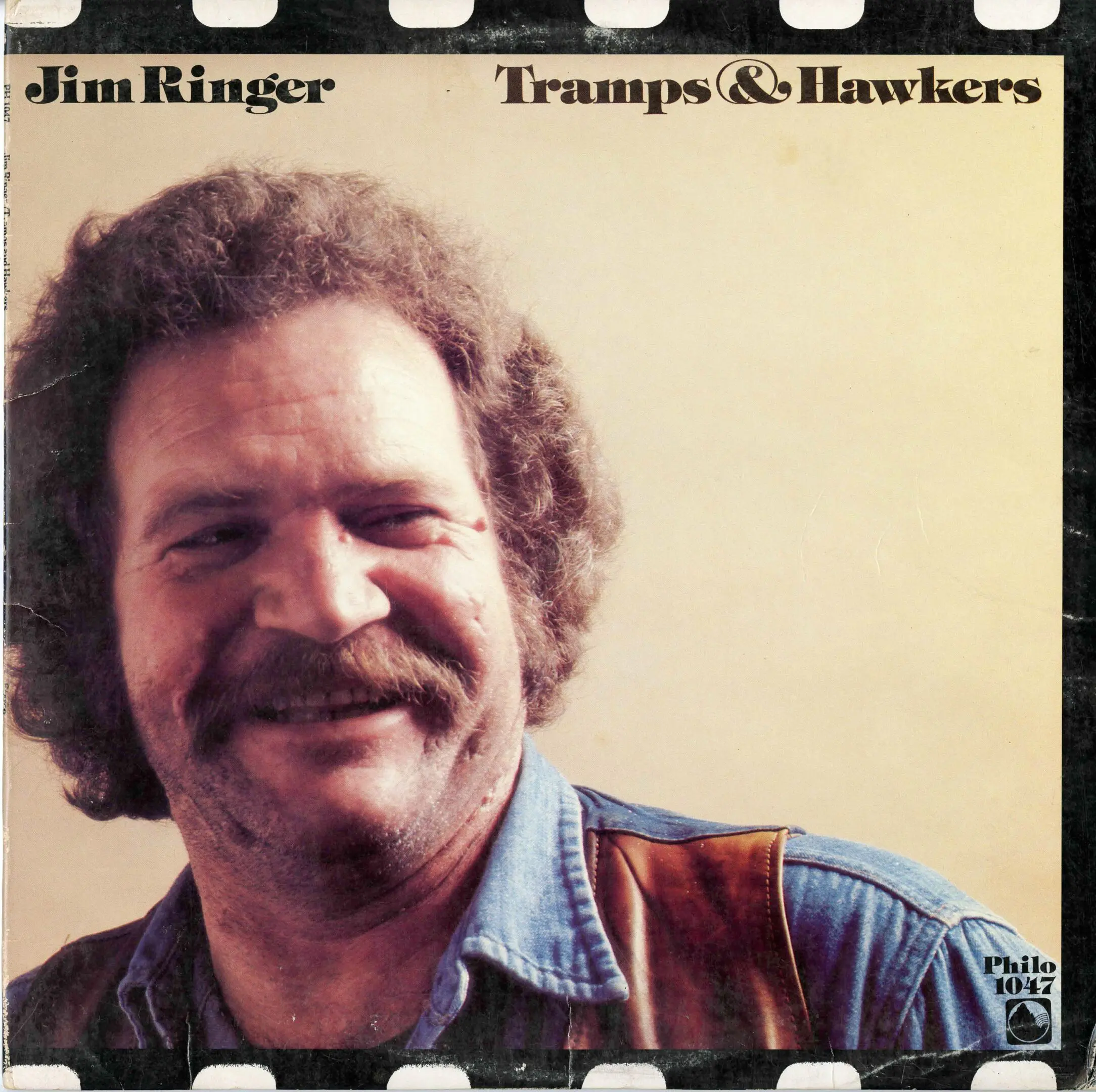 Album cover, man smiling, text "Tramps & Hawkers".