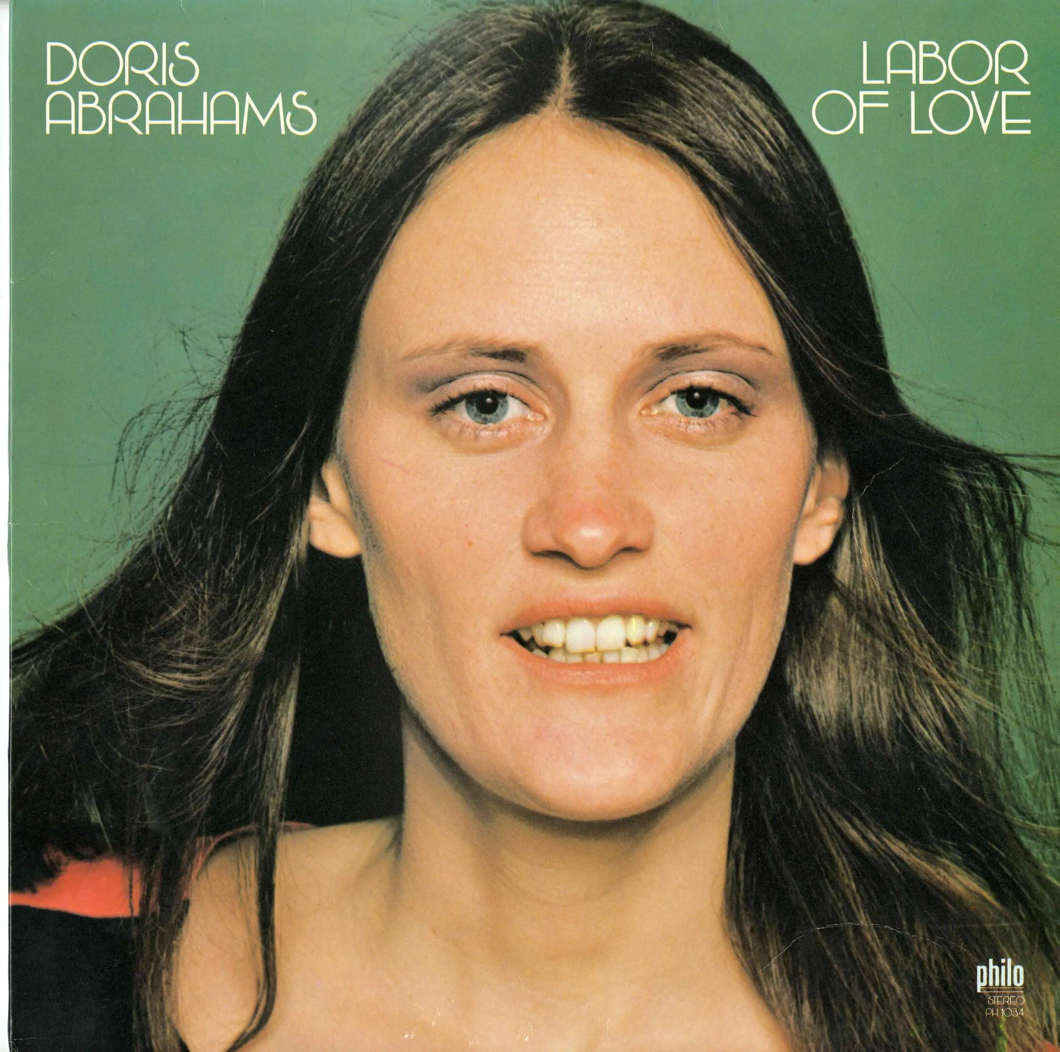 Woman smiling on album cover, green background.