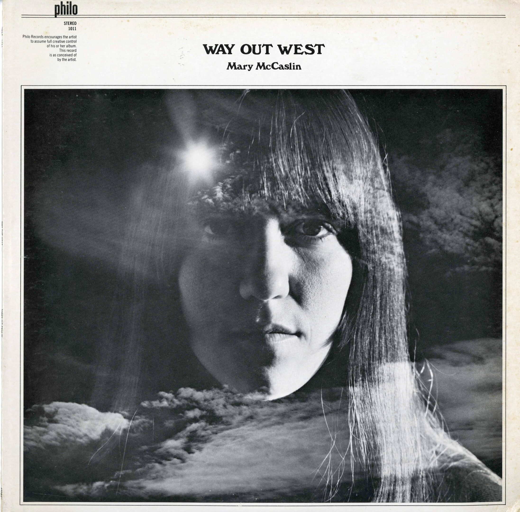 Album cover with woman's face and clouds.