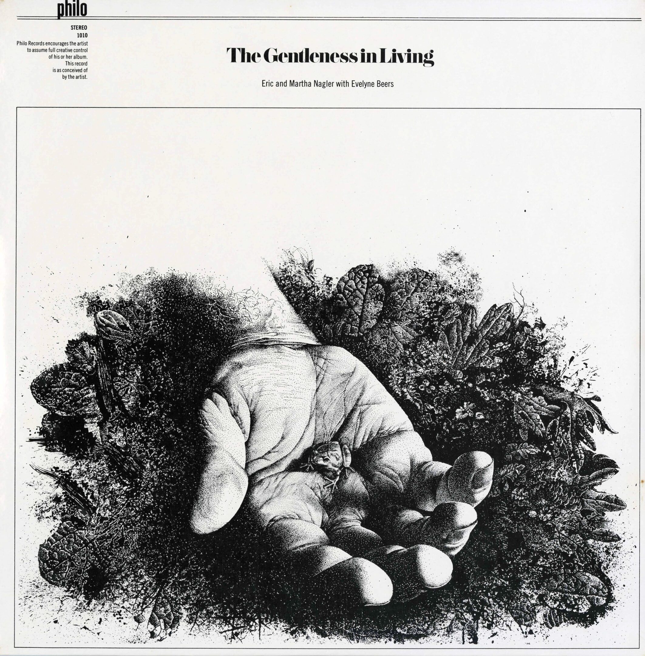 Hand holding small object among foliage.