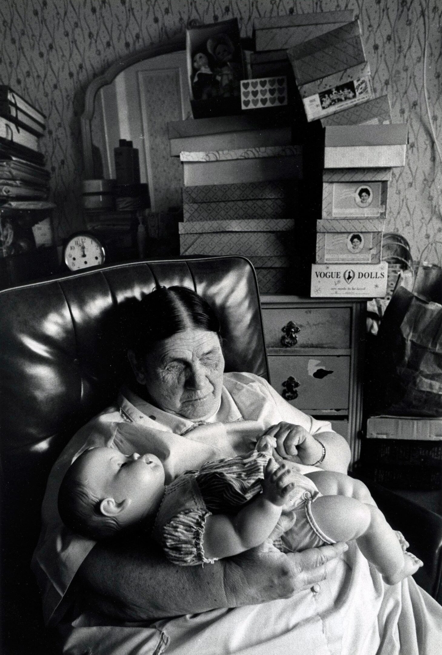 Elderly woman holding a baby doll.