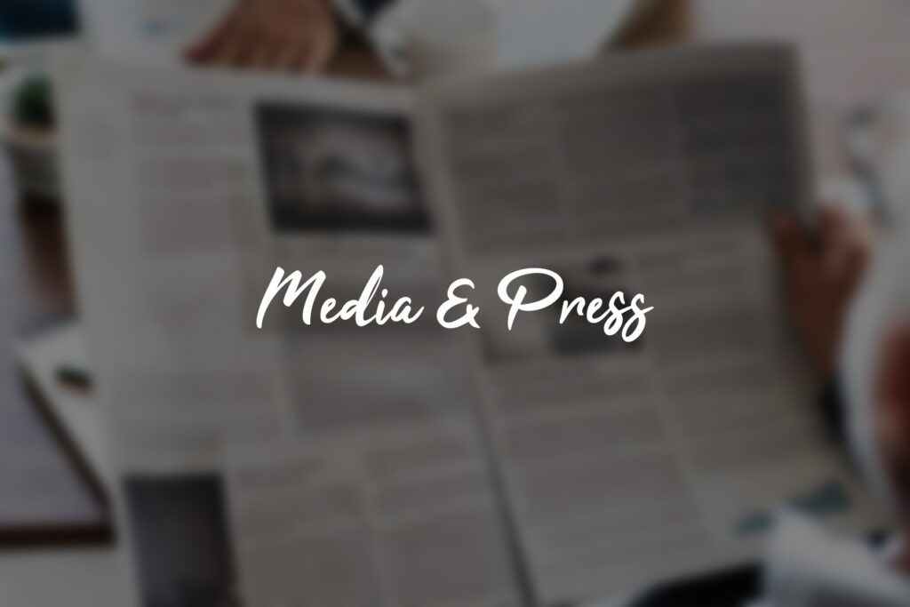 Blurry newspaper with "Media & Press" text.