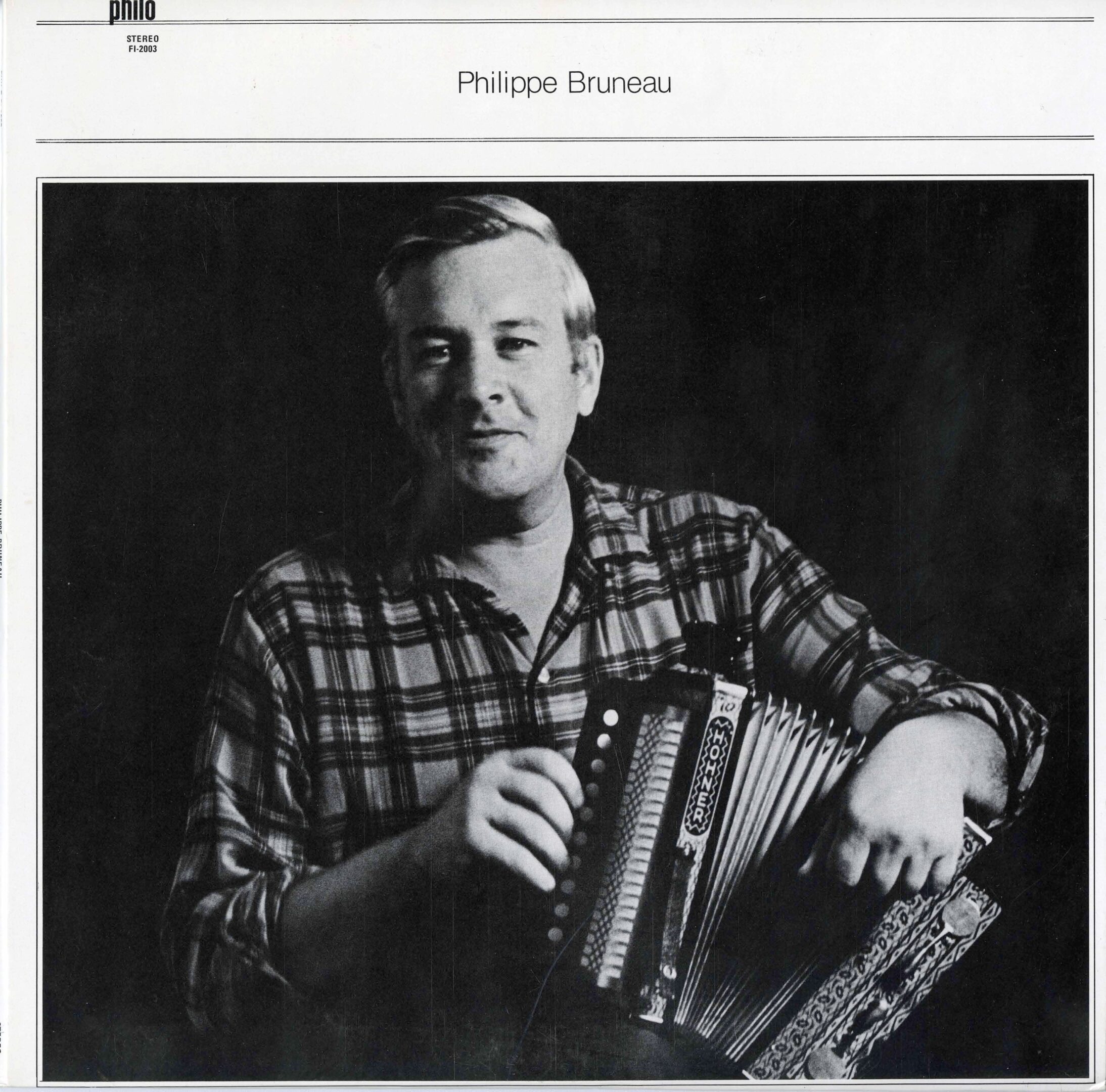 Person playing accordion in black and white.