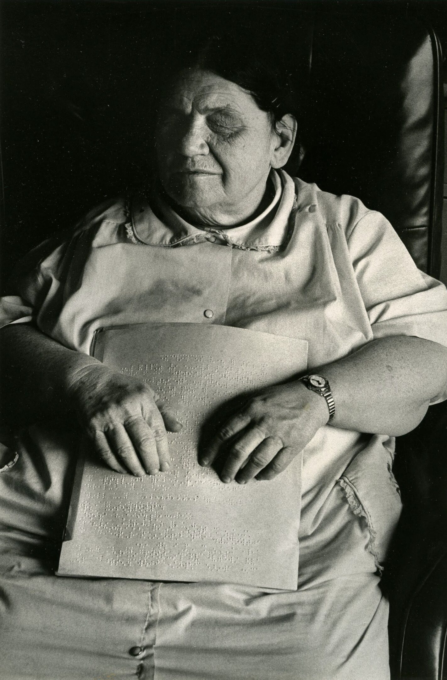 Woman reading braille text with hands.
