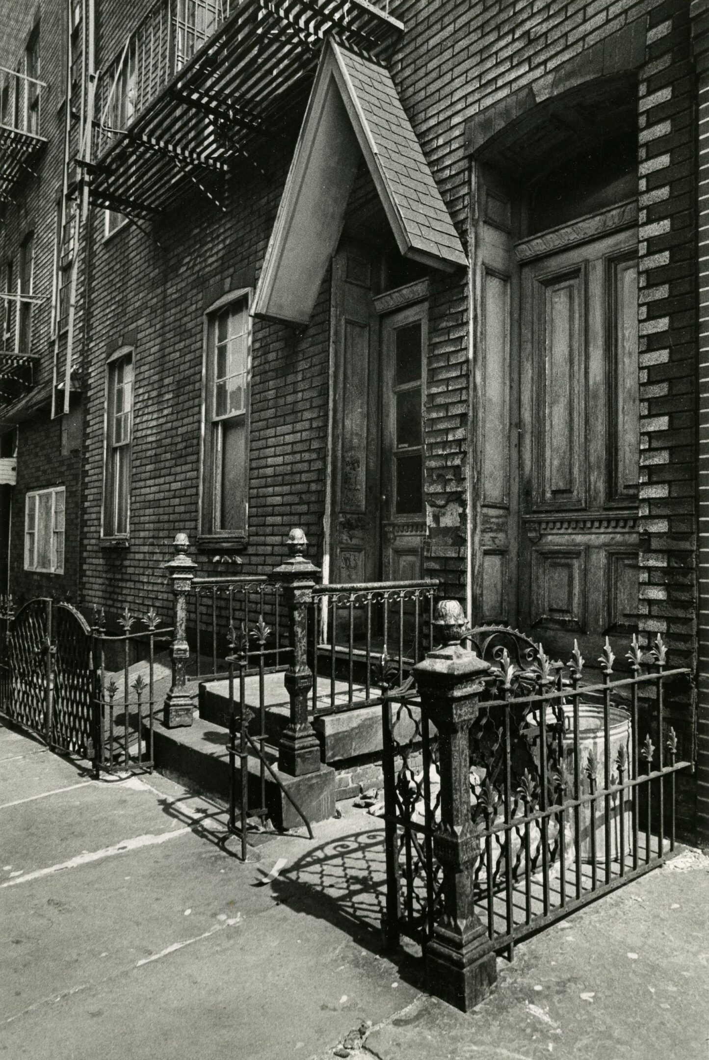 Brick building with wrought iron railings.