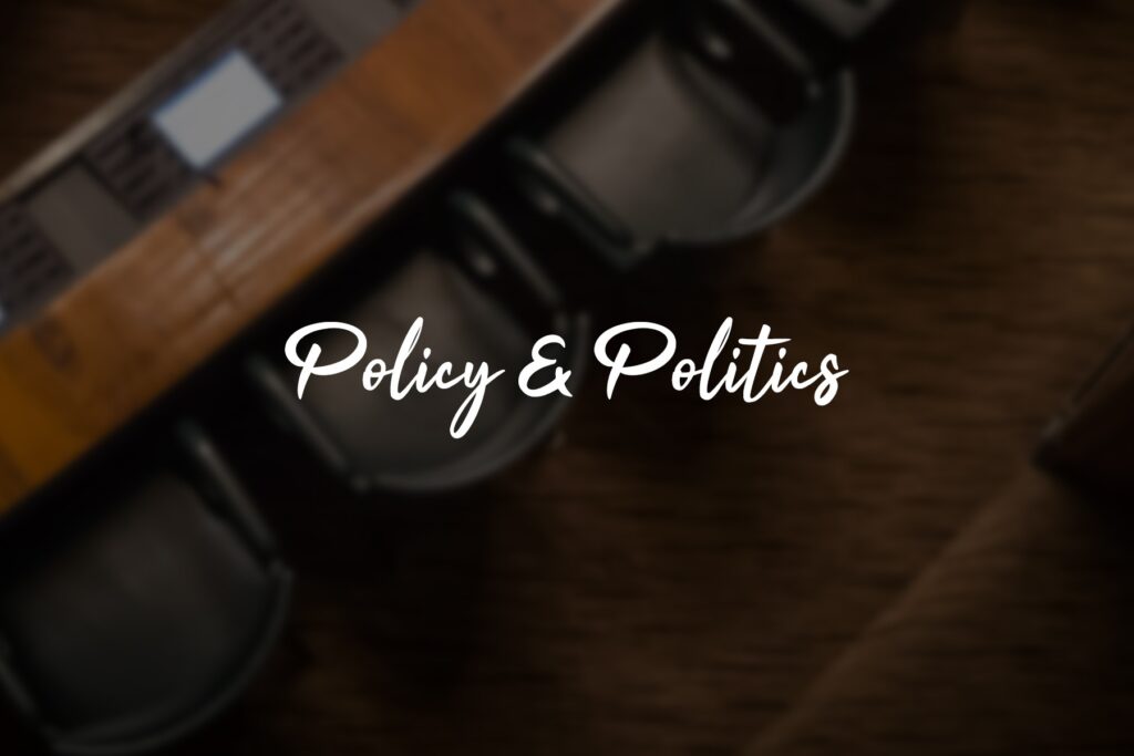 Policy & Politics" text on blurred background.
