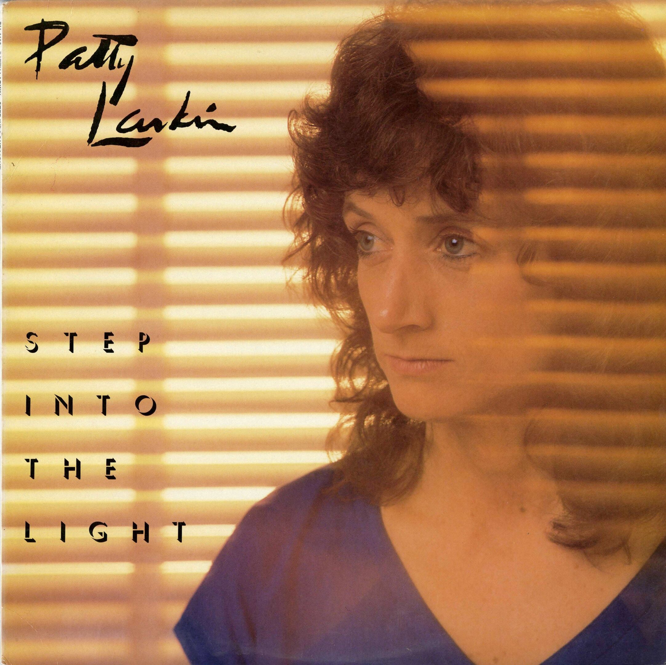 Woman behind blinds, "Step Into the Light".