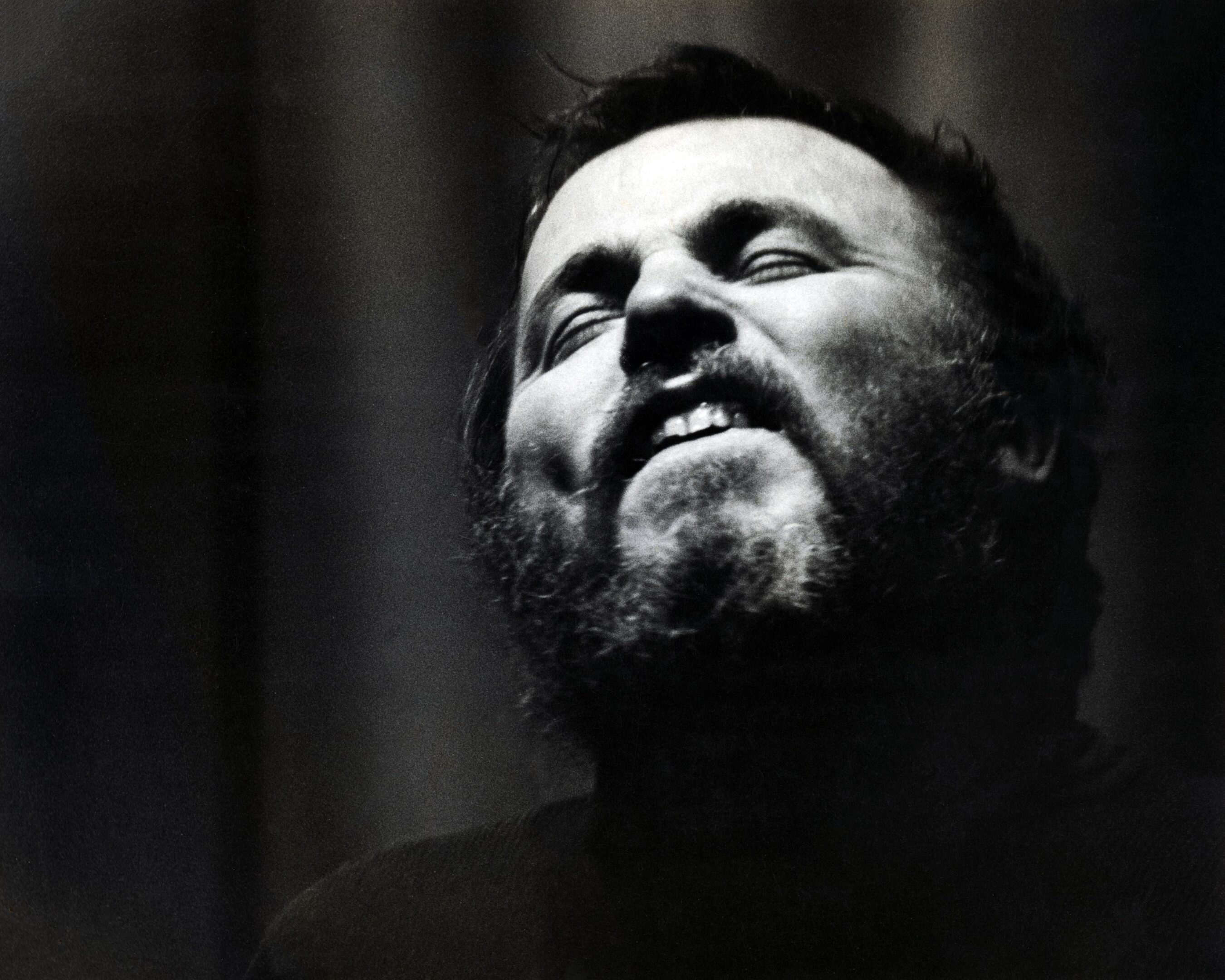 Man passionately singing with eyes closed.
