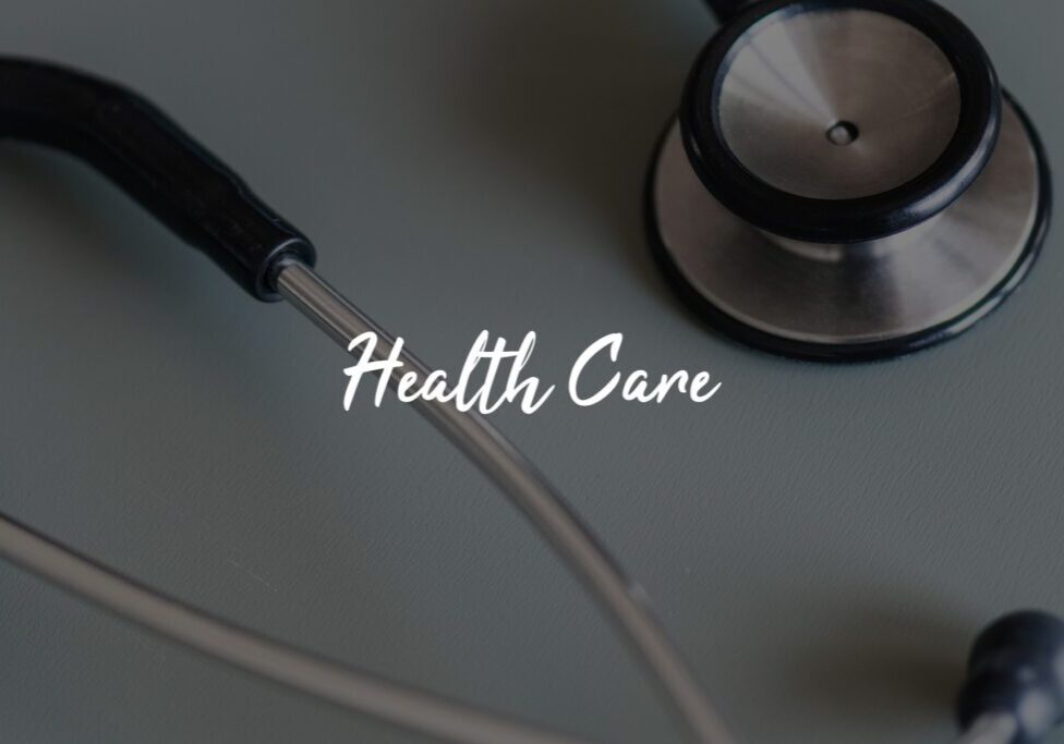 Stethoscope and "Health Care" text on surface. Stethoscope and "Health Care" text on surface.