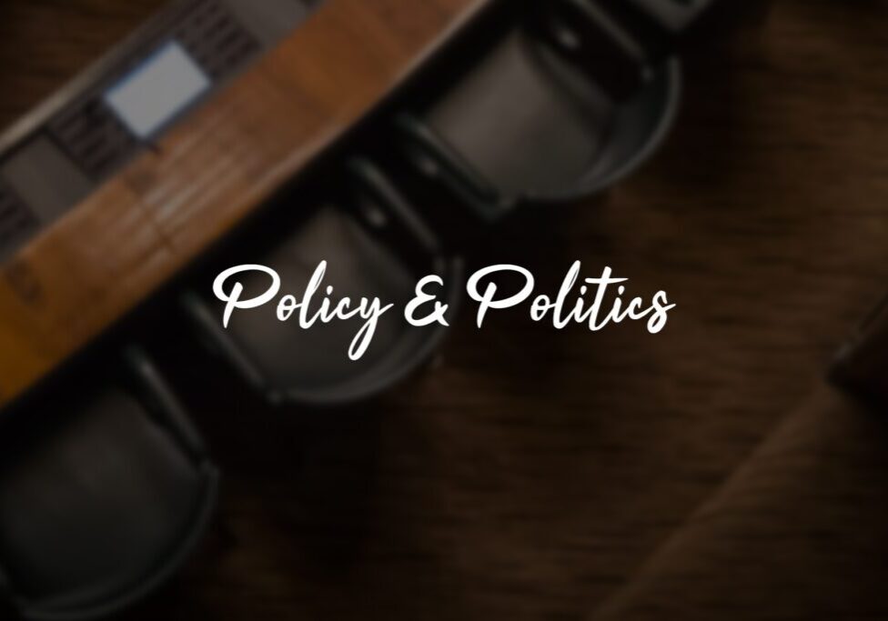 Policy and Politics" text over conference table. Policy and Politics" text over conference table.